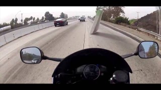 Motorcycle Almost Hits Flying Mattress on Highway